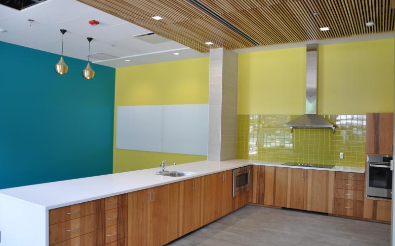 The common space lounge area features a full kitchen