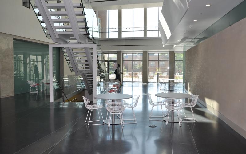The atrium is filled with natural daylight from the four-story glass wall that faces College Avenue
