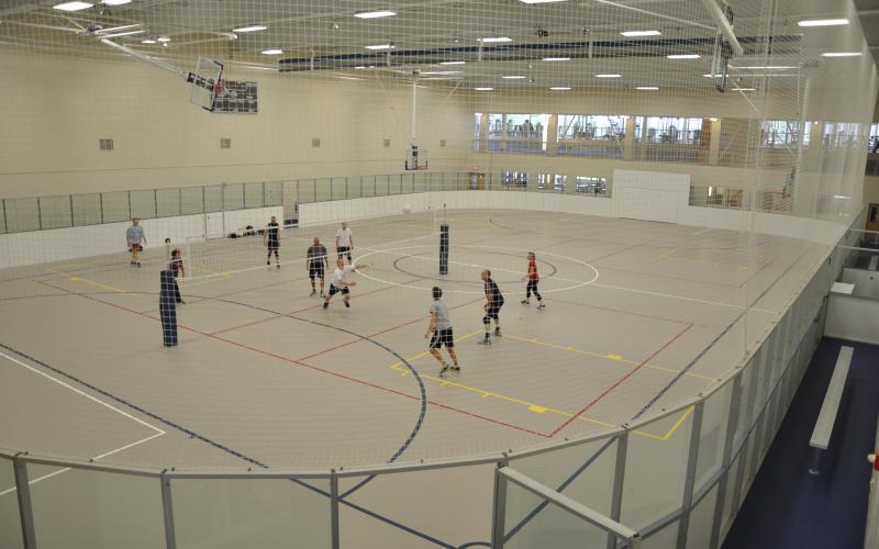 New multi-activity court with metal-framed dasher walls and protective safety netting on the sides/ends keep balls in the playing area